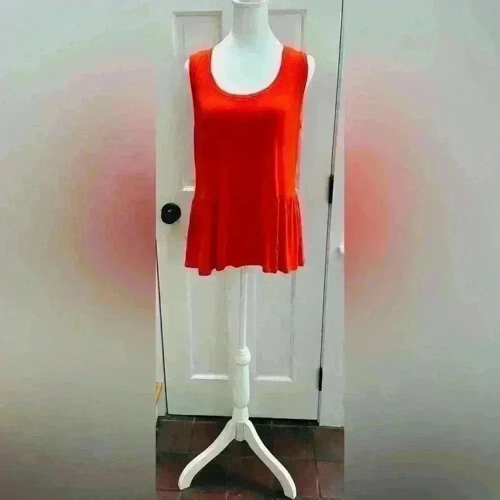 Cabi size M, orange tank top with pleated over hanging the booty area.